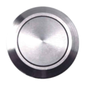 Close-up of a round metallic push button with a brushed stainless steel finish and concentric ring design.