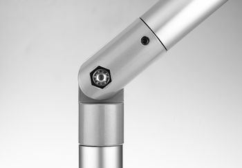 Close-up of a single-shelled angled joint connector made of two connected metallic tubes with a hexagonal bolt and securing screw.