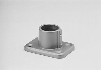 Single-piece floor bearing tube connector with cylindrical threaded sleeve mounted on a rectangular base plate with four mounting holes.